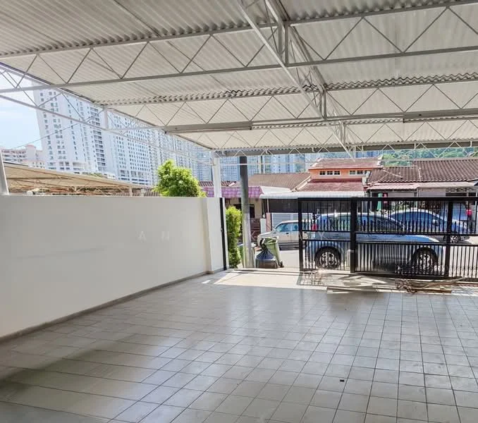 Exterior type: covered parking; features: metal roof, open-air structure, tiled flooring, fenced perimeter, surrounding greenery, adjacent to residential buildings, visible vehicles, urban context; style: modern.