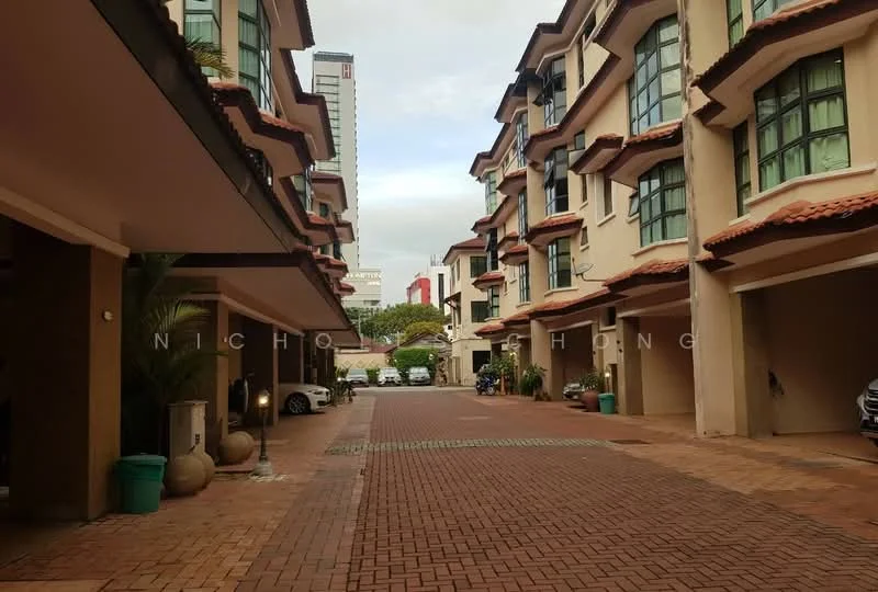 Exterior type: linked terrace house; features: brick-paved driveway, two-storey buildings, arched windows, red tiled roof, manicured landscaping, parking spaces visible, surrounded by greenery, urban context with nearby buildings; style: modern.