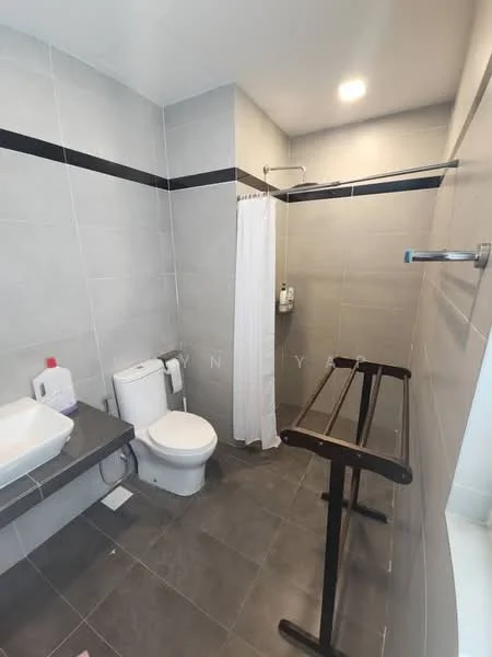 Bathroom features: grey tiled walls, white shower curtain, white toilet, single-sink vanity with rectangular basin, grey countertop, black accent strip on wall, shower area with glass partition, towel rack, recessed lighting, dark grey tiled flooring; style: modern.