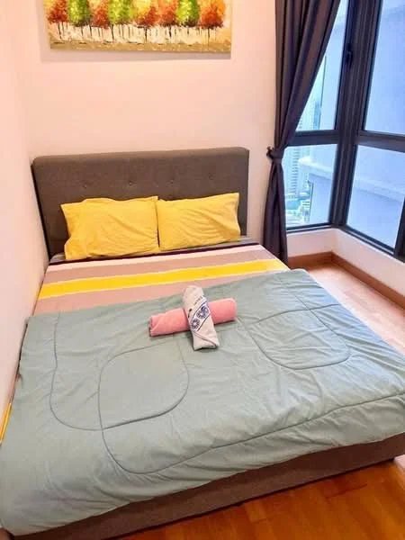 Bedroom features: queen-size bed, grey upholstered headboard, yellow pillowcases, light blue quilted blanket, wooden flooring, floor-to-ceiling windows, curtains in dark grey, framed artwork with trees, corner window view; style: modern; view: city.