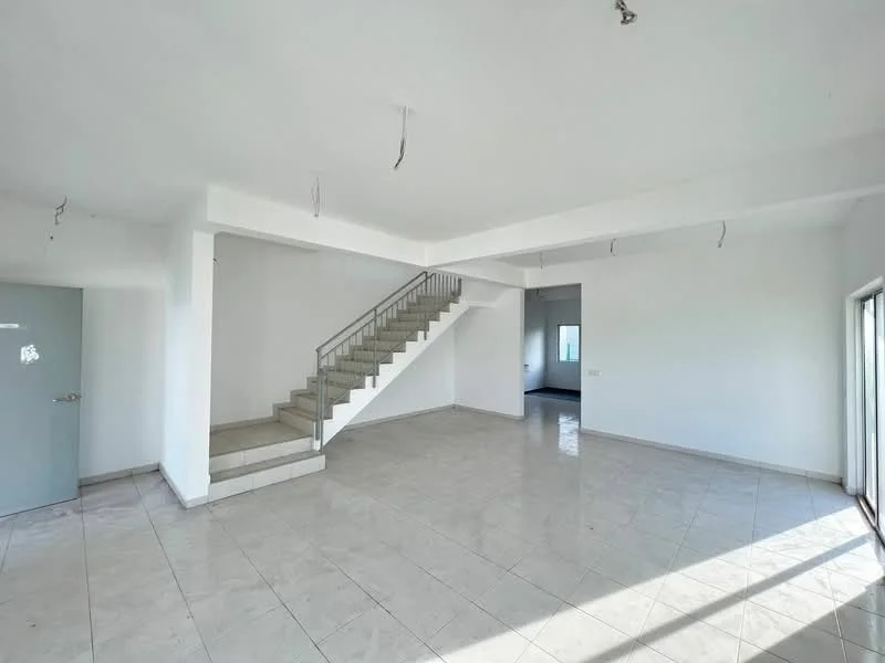 Room features: white painted walls, tile flooring, staircase with metal railing, large windows, natural light, open layout, high ceiling, no visible furniture, neutral color scheme; style: modern.
