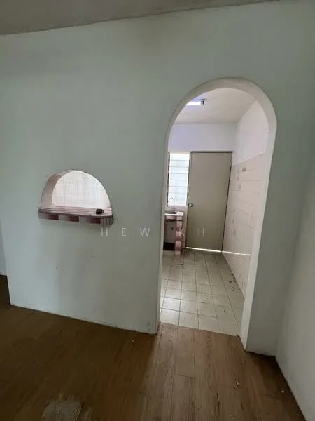 Room features: white painted walls, arched doorway, tile flooring, window with natural light, kitchen area visible, sink area visible, door leading outside.