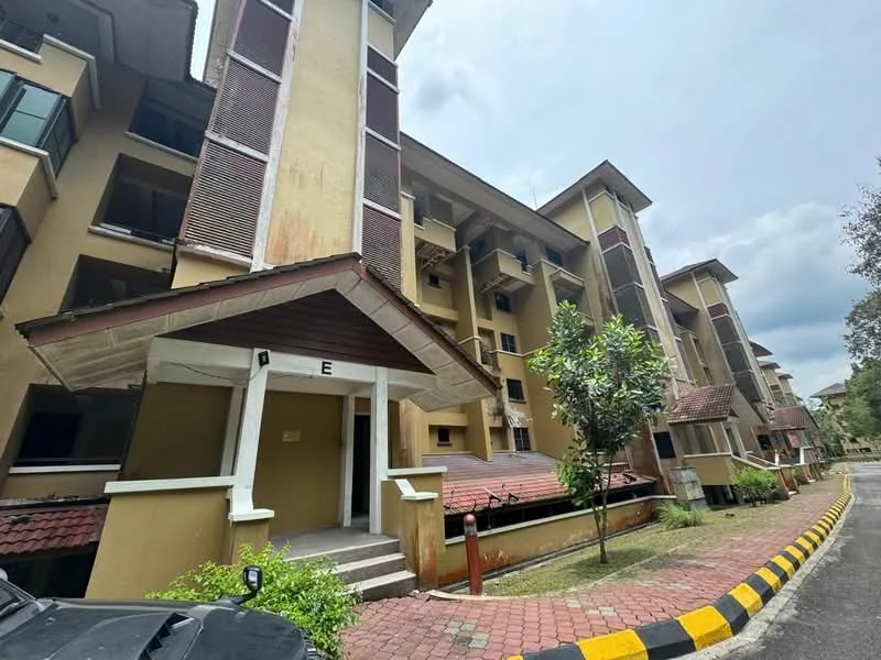 Exterior type: low-rise apartment block; features: yellow painted facade, red tiled roof, balconies with metal railings, landscaped garden area, paved walkway, parking area, multiple storeys, surrounded by greenery; style: modern.
