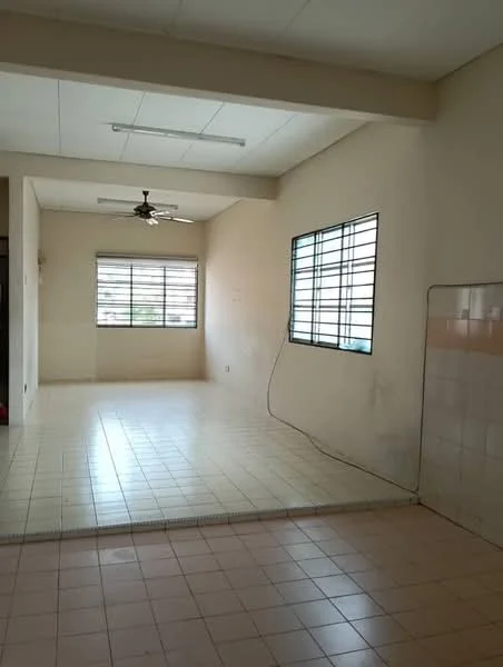 Room features: white painted walls, ceiling with fluorescent lights, tile flooring, two windows with horizontal metal grilles, ceiling fan, corner wall with tiled surface, exposed electrical wiring, open layout; style: minimalist.