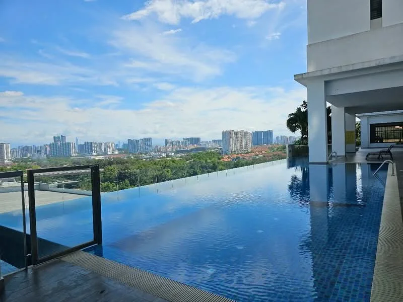Exterior type: high-rise condominium; features: infinity pool, pool deck with loungers, glass railing, city skyline view, surrounded by greenery, tiled pool surface, outdoor seating area; style: modern.