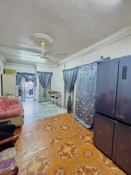 Living features: orange patterned tile flooring, white painted walls, ceiling fan, sofa in pink fabric, refrigerator in dark color, curtains in blue fabric, wooden armchair, open doorway leading to balcony.