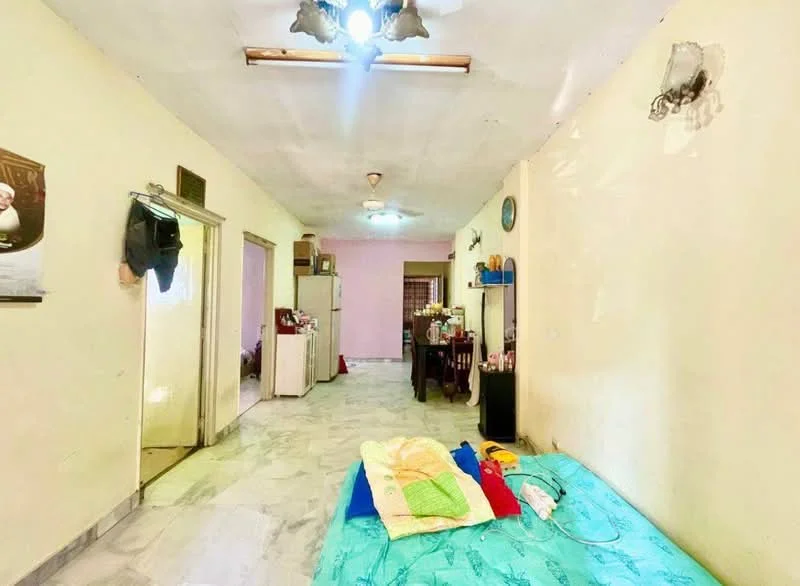 Room features: white painted walls, marble flooring, ceiling fan with light, recessed lighting, dining table, kitchen area visible, bed with colorful bedding, open layout, multiple doorways, decorative wall clock.