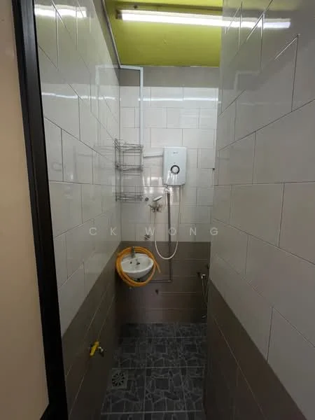 Bathroom features: shower with handheld showerhead, water heater, white tiled walls, grey tiled flooring, wall-mounted storage rack, toilet bowl, yellow toilet seat, drainage grate, ceiling lights; style: modern.