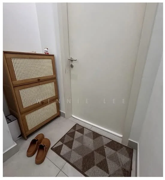 Room features: white painted walls, grey floor tiles, wooden cabinet with rattan front, doormat with geometric pattern, slippers, door with silver handle; style: modern.