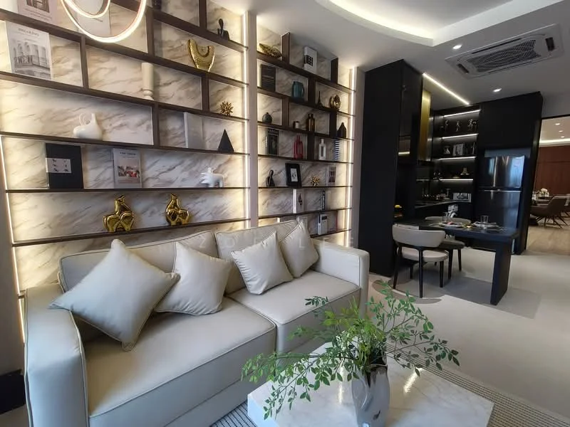 Living features: cream leather sofa with cushions, decorative wall shelving with backlighting, marble accent wall, decorative sculptures on shelves, recessed ceiling lights, area rug with geometric pattern, coffee table with marble top, indoor plant, open layout to dining area, wall-mounted artwork, neutral wall color, built-in cabinetry, dining area visible in background; style: modern.
