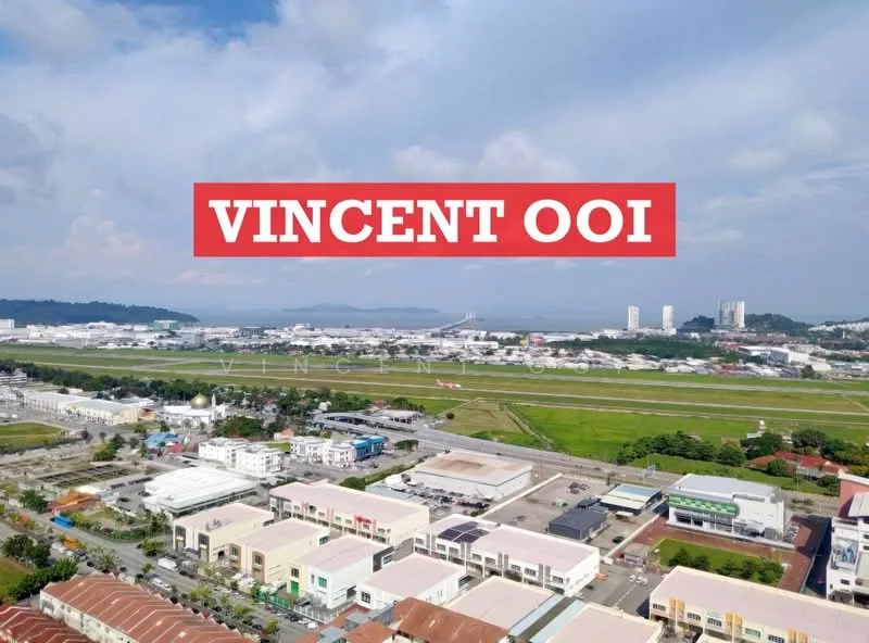 Exterior features: aerial view of commercial buildings, green open space, roadway visible, city skyline in background, industrial area in distance, water body visible, cloudy sky; style: modern.