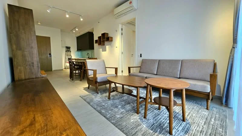 Living features: 3-seater fabric sofa in beige, 2 armchairs in wood, round wooden coffee table, area rug with geometric pattern, wooden TV console, recessed LED downlights, wall-mounted air conditioning unit, large window with sheer curtains, light grey painted walls, tile flooring; style: modern. Room features: open-plan layout leading to kitchen and dining area.