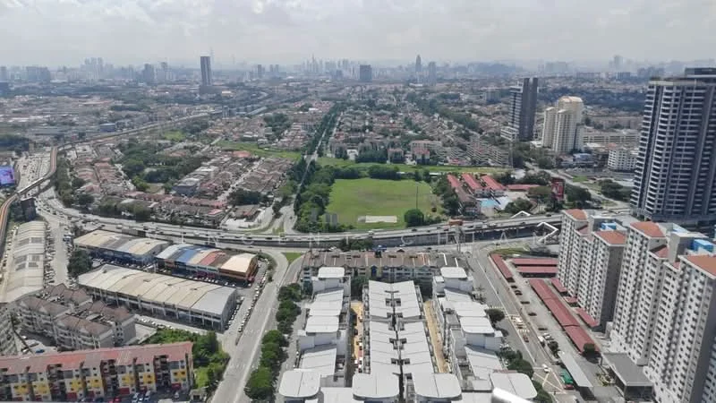 Exterior features: aerial view of urban landscape, mixed residential and commercial buildings, green park area, high-rise buildings in the background, roadways and highways visible, surrounding suburban neighborhoods, clear blue sky, city skyline in distance; style: modern.