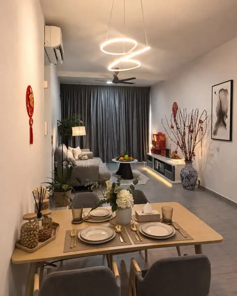 Living features: grey fabric sofa, round coffee table, wall-mounted TV, TV console with storage, decorative vase, floor lamp, 5-blade ceiling fan with light, curtains in grey, decorative wall art, dining table with four chairs, table setting with plates and cutlery, decorative branches in vase, air conditioning unit, light fixture with circular design; style: modern.