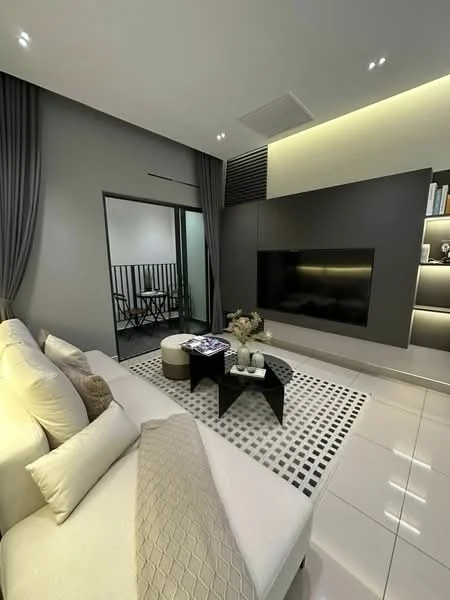 Living features: L-shape sectional sofa in cream, decorative cushions, coffee table with black surface, area rug with geometric pattern, wall-mounted TV, feature wall with recessed lighting, grey painted walls, curtains in dark grey, ceiling with recessed downlights, open access to balcony, glass door leading to balcony, decorative vase on coffee table; style: modern; view: courtyard.