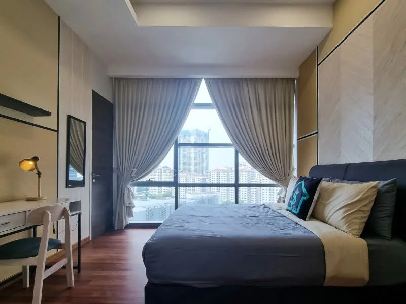 Bedroom features: king-size bed with grey bedding, upholstered headboard, two bedside pillows, desk with chair, table lamp, floor-to-ceiling windows, sheer curtains, dark wood flooring, decorative wall paneling, wall-mounted mirror; style: modern; view: city.