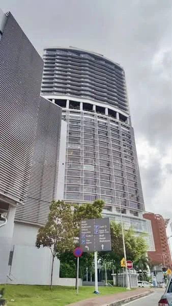 Exterior type: high-rise condominium; features: glass curtain wall, metal cladding, recessed balconies, signage for directions, landscaped area with trees, street view, multiple storeys, modern architectural design; style: modern.
