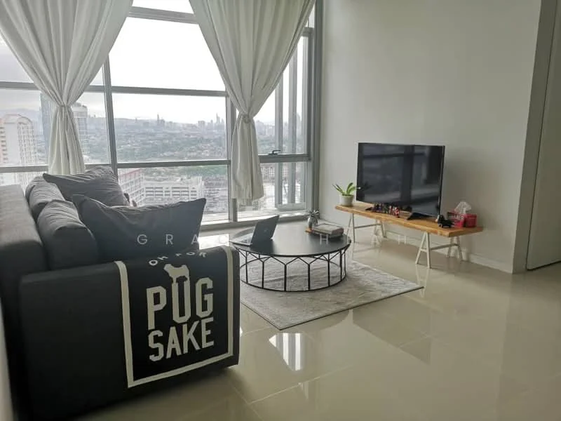 Living features: grey fabric sectional sofa, black and white throw blanket, round coffee table with metal frame, area rug with geometric pattern, wall-mounted TV, wooden TV console, large floor-to-ceiling windows, sheer white curtains, city skyline view, polished ceramic tile flooring; style: modern; view: city.