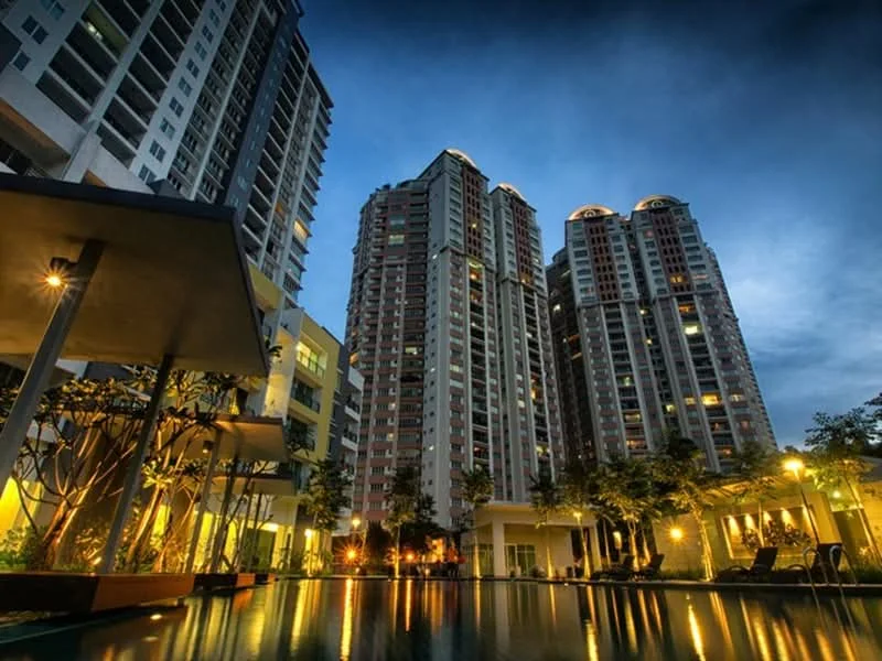 Exterior type: high-rise condominium; features: multiple high-rise buildings, glass curtain wall, landscaped garden, swimming pool with reflection, outdoor lighting, manicured trees, pool deck with loungers, nighttime ambiance; style: modern.