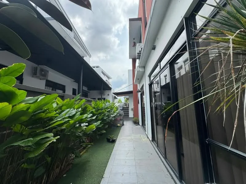Exterior type: linked terrace house; features: landscaped pathway, tropical landscaping with greenery, glass windows, air conditioning units visible, two-storey building, overhanging roof, artificial grass, modern facade, outdoor lighting; style: modern.