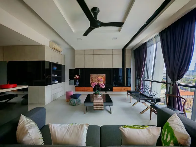Living features: 5-blade ceiling fan with integrated LED light, sofa in grey fabric, decorative cushions, coffee table, wall-mounted TV, black cabinetry, light-coloured cabinetry, recessed ceiling with tray design, floor-to-ceiling windows, dark curtains, wooden accent wall, decorative plant, area rug; style: modern; view: city.