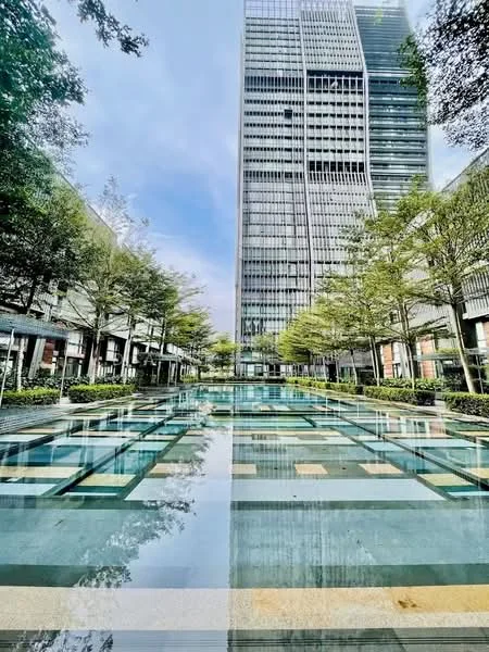 Exterior type: high-rise condominium; features: reflective swimming pool, manicured landscaping, surrounding trees, modern glass facade, multiple levels of the building, outdoor seating areas, paved walkways, water feature, urban setting; style: modern.
