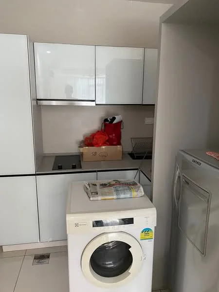 Laundry features: white cabinetry, grey countertop, built-in sink, front-load washing machine, stacked dryer, tile flooring, box of items on countertop, open shelving above sink; style: modern.
