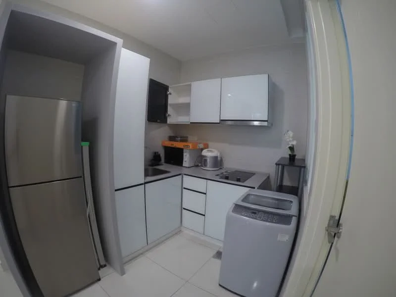 Kitchen features: stainless-steel fridge, white cabinetry with flat-panel design, black countertop, single-bowl stainless-steel sink, chrome pull-down faucet, built-in microwave, washing machine, ceramic tile flooring, white walls, under-cabinet lighting; style: modern.