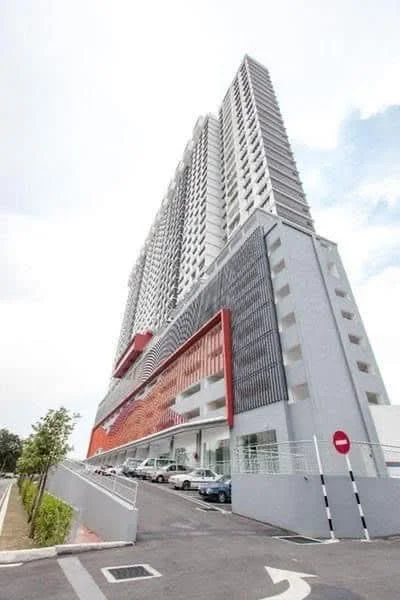 Exterior type: high-rise condominium; features: glass curtain wall, red accent facade, grey painted facade, multi-storey car park, driveway with interlocking pavers, surrounded by greenery; style: modern.