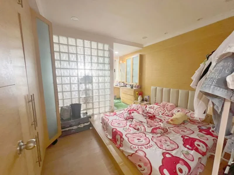 Bedroom features: queen-size bed with pink bear-patterned bedding, wooden headboard, glass block wall, built-in wardrobe with sliding doors, wooden flooring, decorative wall with light wood paneling, green carpet area, nightstand with decorative items; style: modern.