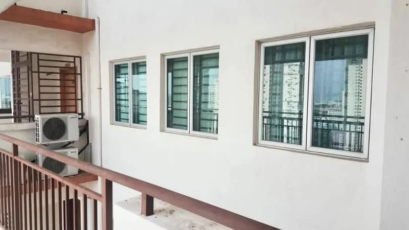 Room features: white painted walls, floor-to-ceiling windows, balcony railing, 1 wall-mounted split AC, concrete flooring; style: modern; view: city.
