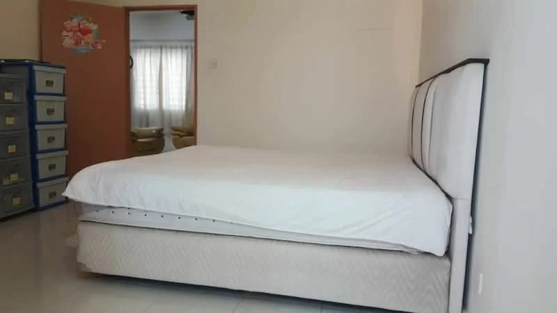 Bedroom features: queen-size bed, white bedding, light-colored walls, tile flooring, window with sheer curtains, built-in wardrobe, decorative wall sticker, nightstand, soft lighting; style: minimalist.
