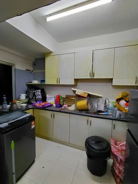 Kitchen features: light grey cabinetry, black countertop, stainless-steel fridge, single-bowl stainless-steel sink, chrome faucet, white tiled backsplash, ceramic tile flooring, overhead fluorescent lighting, garbage bin, various kitchen appliances and utensils, cluttered countertop.