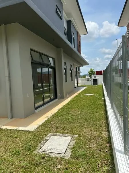 Exterior type: detached bungalow; features: grey painted facade, large windows, manicured lawn, paved walkway, fenced perimeter, side yard, two-storey structure, outdoor space, clear sky, greenery, concrete pathway; style: modern.