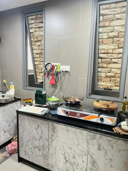 Kitchen features: marble countertop, grey cabinetry, double-basin stainless-steel sink, built-in electric stove, kitchen utensils hanging on wall, exposed brick wall, large windows, cooking pots on stove, food items on countertop, wall-mounted power outlets; style: modern.