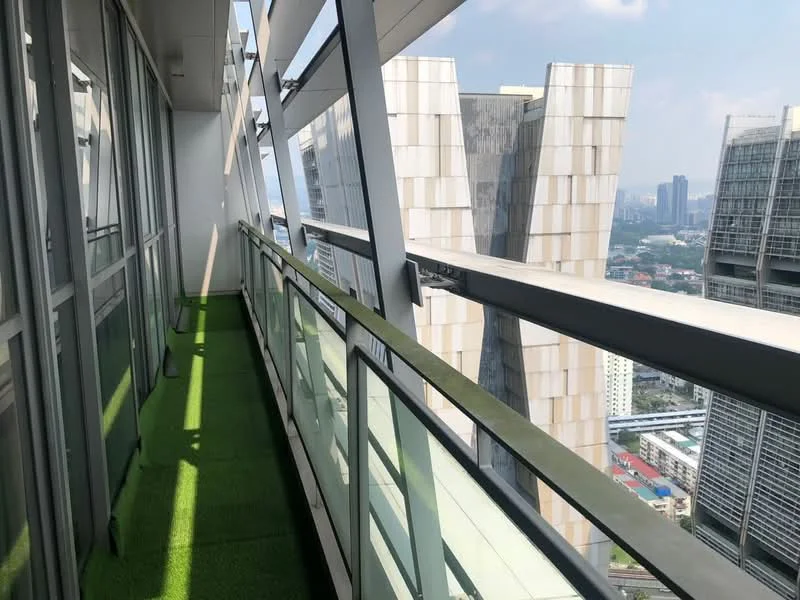 Room features: glass railing, green artificial grass flooring, city skyline view, concrete building facade, metal framing, sunlight casting shadows; style: modern; view: city.