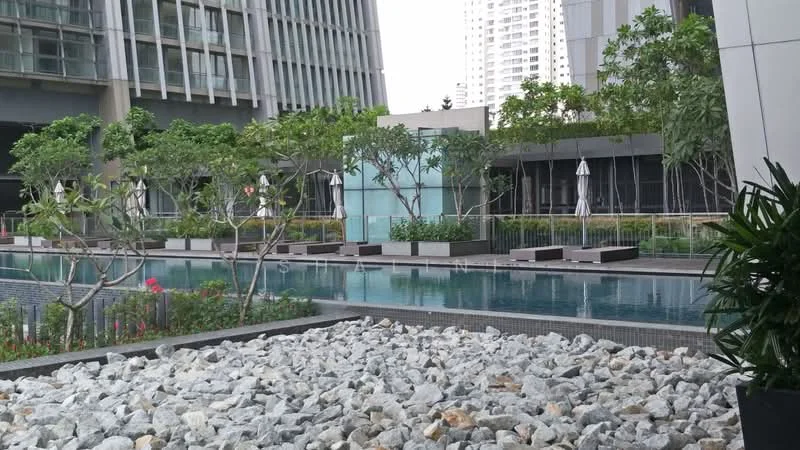 Exterior type: high-rise condominium; features: infinity pool, pool deck with loungers, landscaped garden, manicured lawn, tropical landscaping, stone-paved walkway, water feature, surrounded by greenery; style: modern.