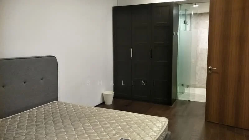 Bedroom features: queen-size bed with grey upholstered headboard, dark wood flooring, white painted walls, built-in wardrobe with sliding doors, glass partition leading to bathroom, small waste bin, door with wooden finish; style: modern.