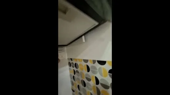 Room features: wall with geometric pattern in yellow, grey, and black, white painted walls, ceiling with recessed lighting, air conditioning unit, crown moulding; style: modern.