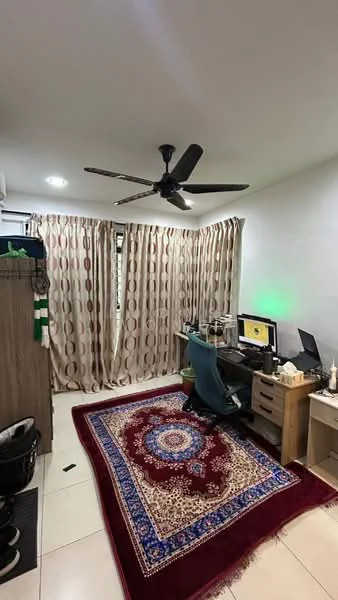 Study features: white painted walls, tile flooring, 5-blade ceiling fan with light, floor-to-ceiling windows with sheer curtains, computer desk with monitor, office chair, wooden storage cabinet, decorative area rug with intricate pattern, wastebasket; style: modern.