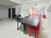 Dining features: long rectangular dining table, black table surface, red plastic dining chairs, white walls, recessed downlights, large windows with sheer curtains, open layout, light-colored flooring, decorative wall art; style: modern.