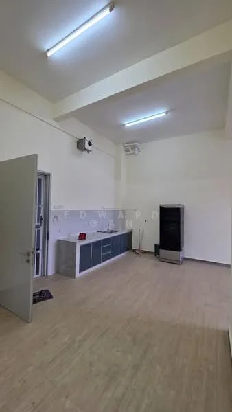 Room features: light wood laminate flooring, white painted walls, ceiling with recessed lighting, wall-mounted split AC unit, grey cabinetry with countertop, black refrigerator, door with glass panel, two fluorescent ceiling lights; style: modern.