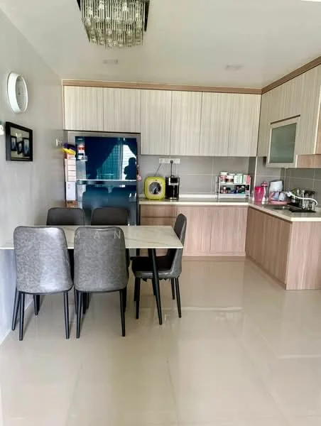 Kitchen features: light wood cabinetry, white countertop, stainless-steel fridge, built-in microwave, coffee machine, kettle, 4-burner gas hob, stainless-steel sink, pendant light fixture, dining table with 4 chairs, ceramic tile flooring, grey accent wall, window with sheer curtains; style: modern.