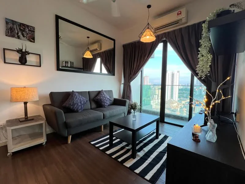 Living features: grey fabric 3-seater sofa, black coffee table, area rug with striped pattern, wall-mounted TV, black TV console, floor-to-ceiling windows, curtains in dark brown, decorative wall mirror, table lamp with beige shade, decorative plant, wall art with nature theme, wooden flooring, ceiling fan with light; style: modern; view: city.