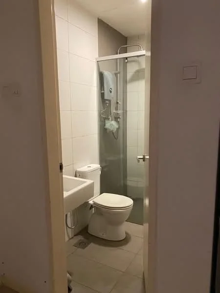 Bathroom features: white tiled walls, grey accent wall, ceramic tile flooring, walk-in shower with glass enclosure, rain shower head, handheld shower, chrome basin mixer, one-piece toilet, single-sink vanity with white cabinet, mirror above sink, water heater, towel rack; style: modern.