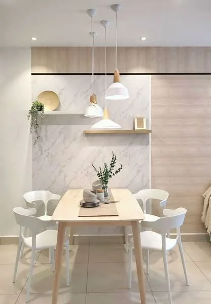 Dining features: light wood dining table, 4 white dining chairs, pendant lighting with white shades, wooden shelf on wall, marble accent wall, light wood paneling, decorative plate on shelf, greenery in vase; style: modern.