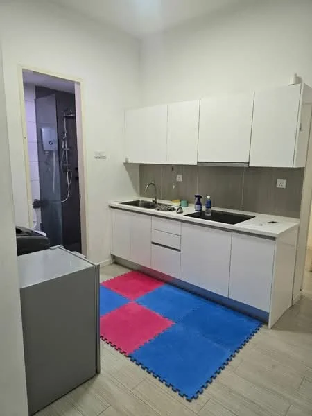 Kitchen features: white cabinetry, single-bowl stainless-steel sink, chrome pull-down faucet, black countertop, built-in refrigerator, grey tiled backsplash, ceramic tile flooring, recessed downlights, kitchen rug with blue and pink squares; style: modern. Room features: shower area, grey tiled walls, glass shower enclosure.