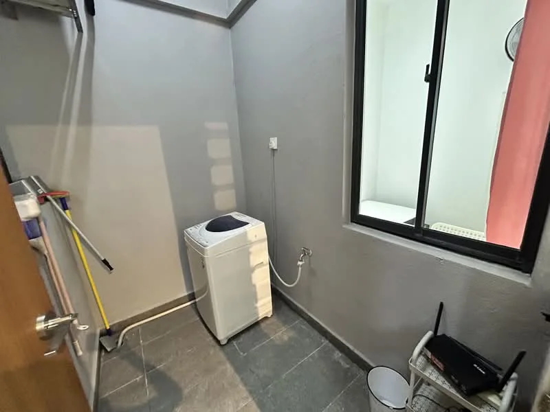 Laundry features: washing machine, grey painted walls, slate tile flooring, window with sheer curtains, utility sink, cleaning supplies, broom, mop, bucket.