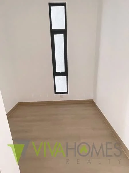 Room features: light wood flooring, white painted walls, narrow vertical window, neutral color scheme, minimalist design; style: modern.