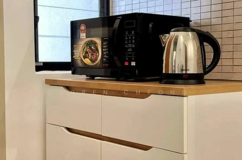 Kitchen features: white cabinetry, wood countertop, black microwave, stainless-steel kettle, grey tiled backsplash, window with natural light; style: modern.